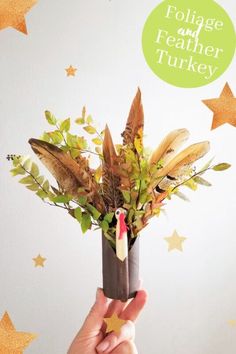 a person holding a fake turkey in a vase filled with feathers and foliage, surrounded by stars