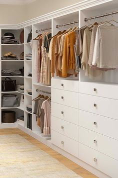 a white closet filled with lots of clothes