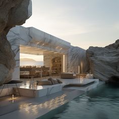 an outdoor living area with water and rocks