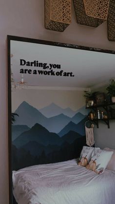 a bedroom with a large poster on the wall above it that says, daring you are a work of art