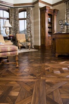 a living room filled with furniture and wooden floors covered in hard wood flooring next to windows