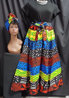 Beautiful African print, black , yellow, blue, green, Red-orange and white full skirt with pockets, 8 panels (very full), ankle length, attached waist tie belt, and matching headwrap. Elastic waist with attached tie belt with pockets. Lovely flowing skirt. Made of 100% Cotton. Skirt can be worn for cultural events, Kwanzaa, or everyday all occasions. It is a one-piece jumper. Pants have wide palazzo legs, looks like a dress. It's a combo. Size -Free size (FITS most Large to 3XL) Measurements: Wa Multicolor Elastic Waistband Skirt, Vibrant Multicolor Long Skirt, Multicolor Long Skirt With Elastic Waistband, Belt With Pockets, Jumper Pants, One Piece Jumper, African Print Skirt, Elastic Skirt, Handkerchief Dress