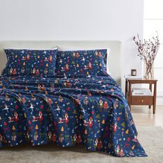 a bed with mickey mouse comforter and matching sheets