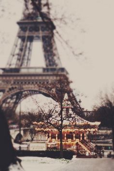 the eiffel tower is lit up with christmas lights