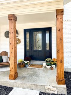 the front porch is decorated with flowers and potted plants