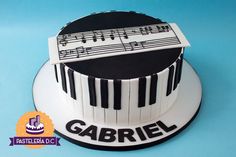 a cake decorated with music notes and piano keys