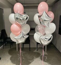 some balloons are in the shape of animals with pink tails and tailes on them