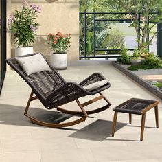 a rocking chair and foot stool on a patio