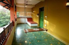 a room with a swing and green door