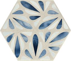 a blue and white hexagonal tile pattern with leaves on it's sides