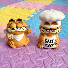 two salt and pepper shakers sitting on top of a table