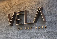 we are looking at the sign on the side of a building that says vela on the park