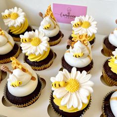 there are many cupcakes decorated with yellow and white frosting on the top