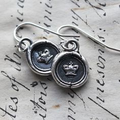 "A dainty pair of wax seal crown earrings, unique and one-of-a-kind, they are handmade in sterling silver using an antique Victorian era wax seal dating to the early 1800's. They come thoughtfully presented and ready for gifting. ►YOUR JEWELRY COMES BEAUTIFULLY GIFT BOXED and INCLUDES a CARD with the CHARMS MEANING & SYMBOLISM, and a CARE CARD! ◄ D E T A I L S: * 925 Sterling Silver * Wax Seal Crown is 3/8\" in diameter * Handmade in the USA > > See OTHER HEART JEWELRY HERE: https://ww Silver Heirloom Earrings Gift, Silver Vintage Charm Earrings For Gift, Heirloom Silver Earrings For Gift, Heirloom Sterling Silver Earrings For Gift, Silver Earrings With Vintage Charm For Gift, Silver Earrings With Vintage Charm As Gift, Heirloom Sterling Silver Earrings, Elegant Stamped Earrings As Gift, Seal Earrings