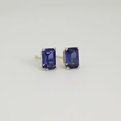 Elevate your style with our 14k Gold Emerald Cut Blue Sapphire Stud Earrings, perfect for adding a touch of sophistication and elegance to any outfit. These emerald cut sapphire stud earrings are the perfect size for everyday wear or special occasions, and their brilliant blue color is sure to catch the eye and make a statement. These exquisite studs feature genuine sapphire gemstones that are lab-grown for a sustainable and ethical choice. Unlike simulated or CZ stones, lab-grown sapphires are Classic Octagon Gemstone Earrings, Classic Baguette Cut Gemstone Earrings, Modern Yellow Gold Emerald Cut Earrings, Classic Sapphire Earrings With Diamond Cut, 14k Gold Emerald Cut Earrings For Gift, Modern Emerald Cut Earrings For Gift, Formal 14k Gold Octagon Earrings, Classic Tanzanite Earrings For Anniversary, Classic Octagon Earrings