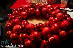 a red christmas ornament wreath sitting on top of a table