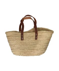 a large straw bag with leather handles on the handle is shown in front of a white background