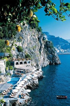 an outdoor swimming pool next to the ocean