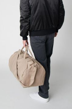 Nothing beats the simplicity and functionality of a good duffel bag—except maybe a Certified Organic Cotton duffel bag made with the good of the environment and people in mind! Durable and versatile, the Bumi Duffel Bag is sustainably and ethically made with 14-oz heavy duty Fairtrade organic cotton canvas. The perfect size for a spontaneous weekend getaway or when you need a little more room to haul daily needed gear for work or athletics, the Bumi Duffel has an adjustable shoulder strap, an ou Practical Tote Duffle Bag For Overnight Trips, Practical Duffle Bag With Luggage Sleeve, Practical Duffle Bag With Top Carry Handle For On-the-go, Practical Duffle Bag With Top Carry Handle, Practical Duffle Bag With Adjustable Strap For On-the-go, Practical Large Capacity Weekender Bag, Practical Duffle Bag For Everyday Use, Practical Everyday Duffle Bag With Luggage Sleeve, Casual Beige Duffle Bag With Luggage Sleeve