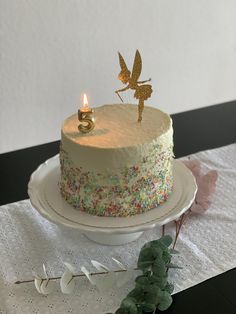 there is a cake with sprinkles and a candle on it