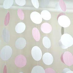 pink and white paper circles hanging from the ceiling