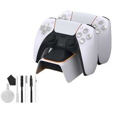 three white controllers with black and orange trims next to each other on a white background