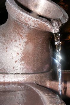 a close up of a metal object with water coming out of it