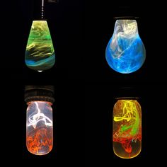 four glass vases with different colored liquids in them and one is filled with liquid