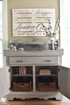 a white dresser with baskets on it and a wooden sign above the top that says amazing grace