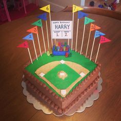 a birthday cake for a baseball player on top of a table in the shape of a base