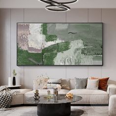 a living room filled with furniture and a large painting on the wall above it's coffee table