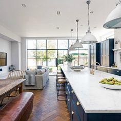 a large kitchen with an island in the middle and lots of counter space on one side