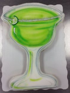 a green drink with a slice of lime in it