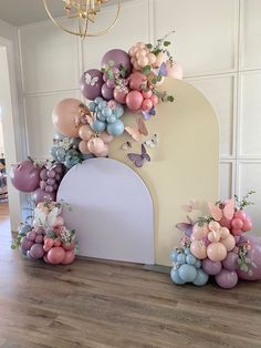 balloons and flowers are arranged on the wall