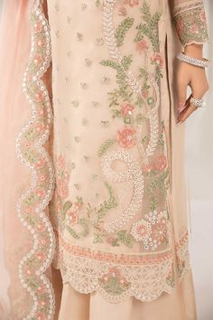 Peach Embroidered Maria B Luxury Formal Pakistani Party Dress showcasing a straight-cut shirt elevated with panni work, lustrous sequins, tilla, and thread embroidery. Delivery: 7 Business Days Detailed Description: SKU: PB675 Detailing: Embroidery, Threads Color: Peach Fabric: Net, Organza Design: Fully Embroidered dress Event: Festive, Party wear Peach Suit Embroidery Design, Peach Embroidered Dress For Eid, Peach Dress With Intricate Embroidery For Eid, Festive Embroidered Peach Salwar Kameez, Luxury Peach Set With Intricate Embroidery, Saree Embroidery Design, Graphic Shirt Design, Embroidery Fashion Detail, Simple Embroidery Designs