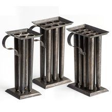 three metal vases sitting on top of each other