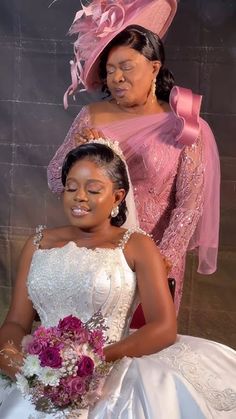 two women in wedding gowns are posing for the camera