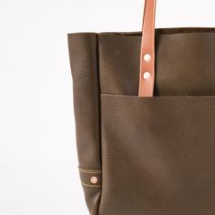 The Olive Cypress Carryall Tote is one of our biggest and most beautiful leather tote bags (and a perfect work tote). Olive Cypress is a pillowy leather with a pebbled grain, light sheen, and vibrant olive green color. The Olive Cypress Carryall Tote comes standard with Tan handles. Olive Leather Tote Shoulder Bag, Olive Leather Tote Bag, Olive Leather Bag With Leather Handles, Green Leather Bags With Rolled Handles, Green Leather Shoulder Bag With Rolled Handles, Leather Tote Bags, Carryall Tote, Work Tote, Large Leather Tote