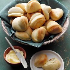 bread rolls and butter in a bowl on a table