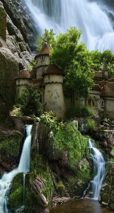 a waterfall and some houses in the woods