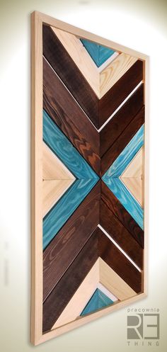 an art piece made out of wood with blue and brown strips