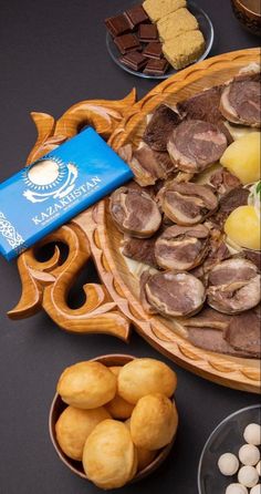 a platter filled with lots of different types of food on top of a table