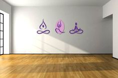 an empty room with three yoga symbols on the wall