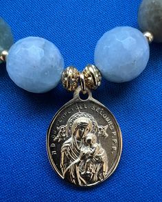 "Mary shines bright in this special bracelet featuring a gold plated Our Lady of Perpetual Help medal as its focal point! Mary is surrounded by 12mm aquamarine beads accented with Bali vermeil spacer beads and Japanese seed beads. The symbol for the Sacred Heart of Jesus is on the back of the medal. This handcrafted stretch bracelet is 7\" in diameter. The medal is 3/4\" wide and 14/16\" long. Cowgirls and Saints gift box included." Virgin Mary Bracelet, Our Lady Of Perpetual Help, Lady Of Perpetual Help, Vintage Hand Tools, Tooled Leather Purse, Aquamarine Beads, Silver Bead Necklace, Miraculous Medal, Hand Tooled Leather