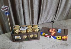 a table topped with cakes and candy bars