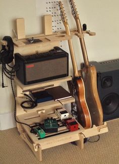 a guitar and amp are sitting on a shelf