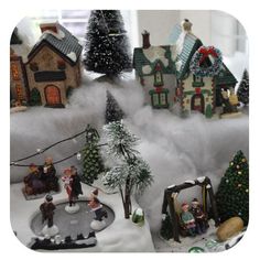 a christmas scene with miniature houses and trees