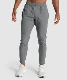 REDEFINING YOUR POTENTIAL Give some extra power, poise and purpose to your training. The Arrival Woven Joggers are focused on performance with a supportive fit, light-stretch polyester-elastane blend and customisable wear, keeping your movement weightless and your efforts effective. - Slim fit- Lightweight material- Tapered to leg- Elasticated drawcord waistband- Zipped ankle cuffs for easy wear- Open side pocket- Heat-sealed Gymshark logo to thigh- 87% Polyester, 13% Elastane- Model is 6'0" and Gymshark Joggers, Husband Clothes, Gym Joggers, Joggers Outfit, Gym Fits, Grey Joggers, The Arrival, Ankle Cuffs, Mens Winter Fashion