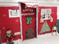 an office decorated for christmas with santa's workshop on the door and decorations around it