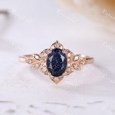 This is an Blue Sandstone engagement ring rose gold. The stones are Blue Sandstone and VVS man made cz diamond. The center Blue Sandstone is about 5x7mm Oval Cut. This ring can also be made in genuine solid 10k, 14k, 18k gold or Platinum, and all the rings in my shop can be customized too! If you want to know more details about the ring, just contact with me anytime! If you want to customize the ring, just contact with me anytime! If you want to make a custom jewelry, just contact with me anytim Blue Sapphire And Diamond Engagement Ring, Black Sandstone Engagement Ring, Blue Goldstone Ring, Feyre Ring, Sandstone Wedding Ring, Star Wars Wedding Ring, Blue Sandstone Ring, Blue Sandstone Engagement Ring, Sapphire Ring Vintage